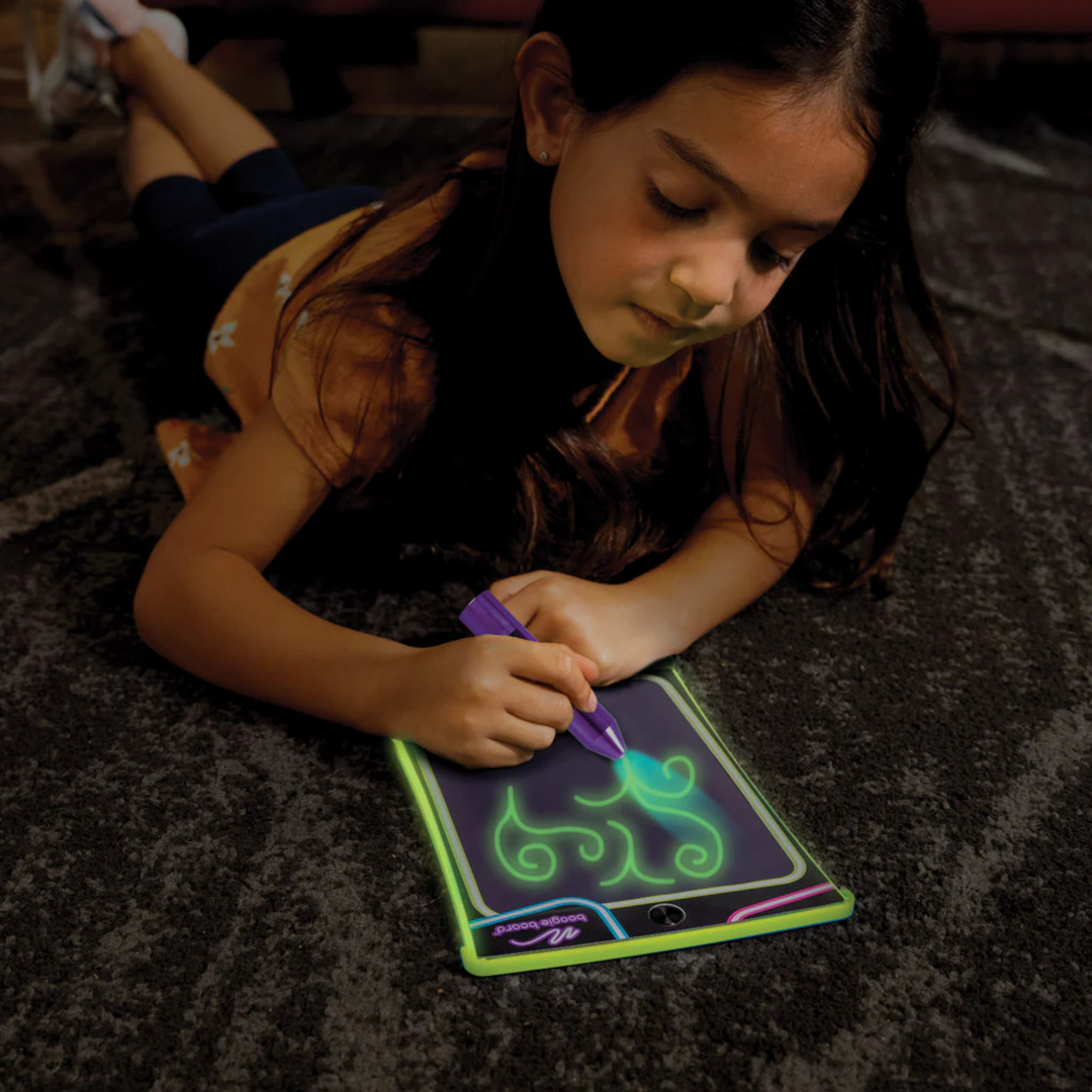 a girl using Magic Sketch Glow Drawing Tablet