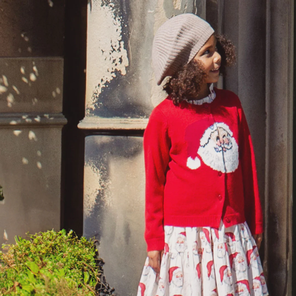 a girl wearing Maude Sweater - Red Santa