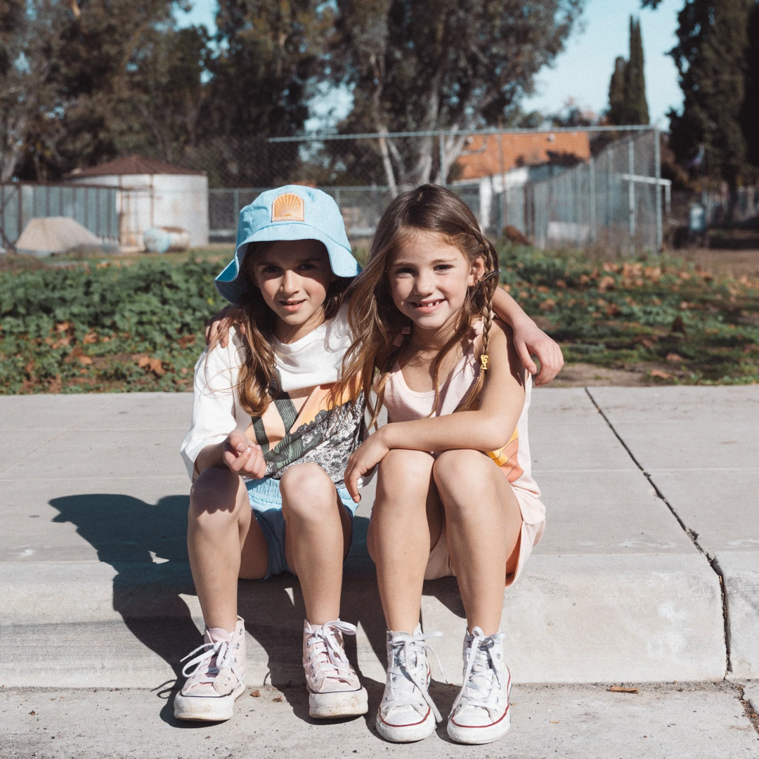 teenage girls wearing No Bad Vibes Bucket Hat in Denim Chambray