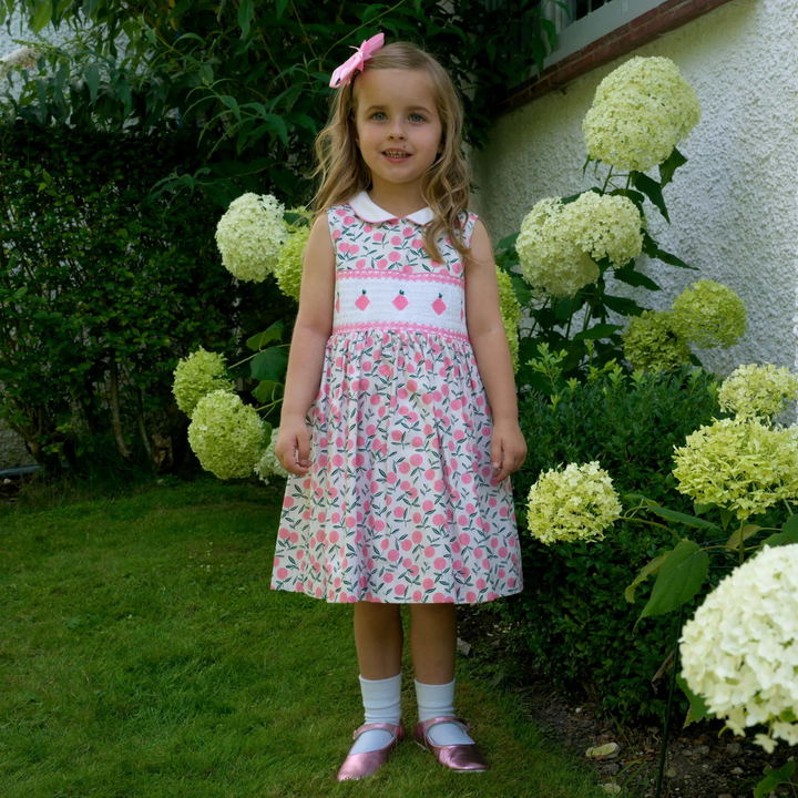 a girl at the garden wearing Peachie Smocked Dress