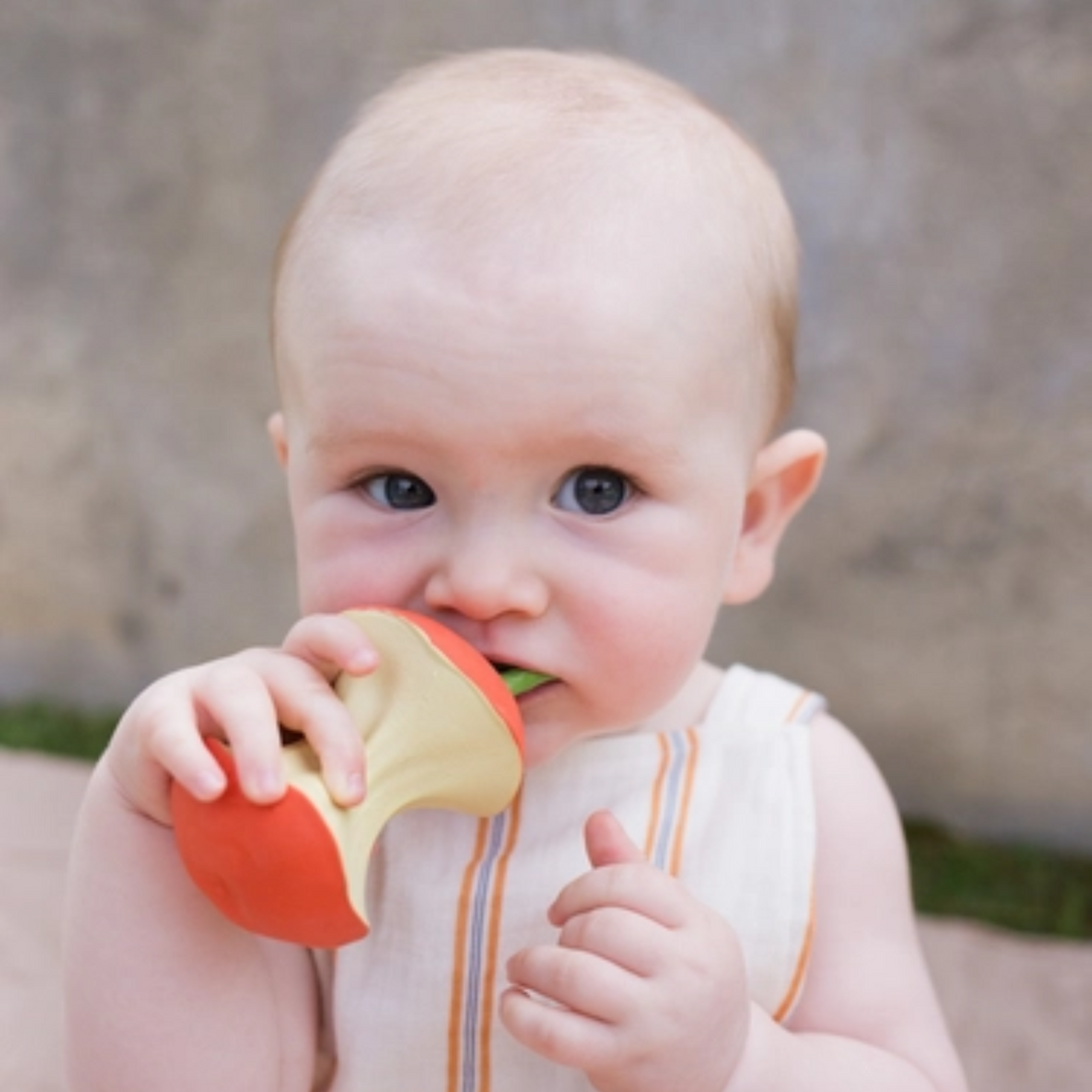 a baby biting the Pepa the Apple