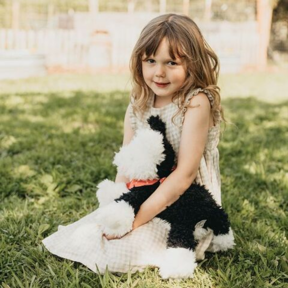 a little girl hugging the Pepper the Farm Dog