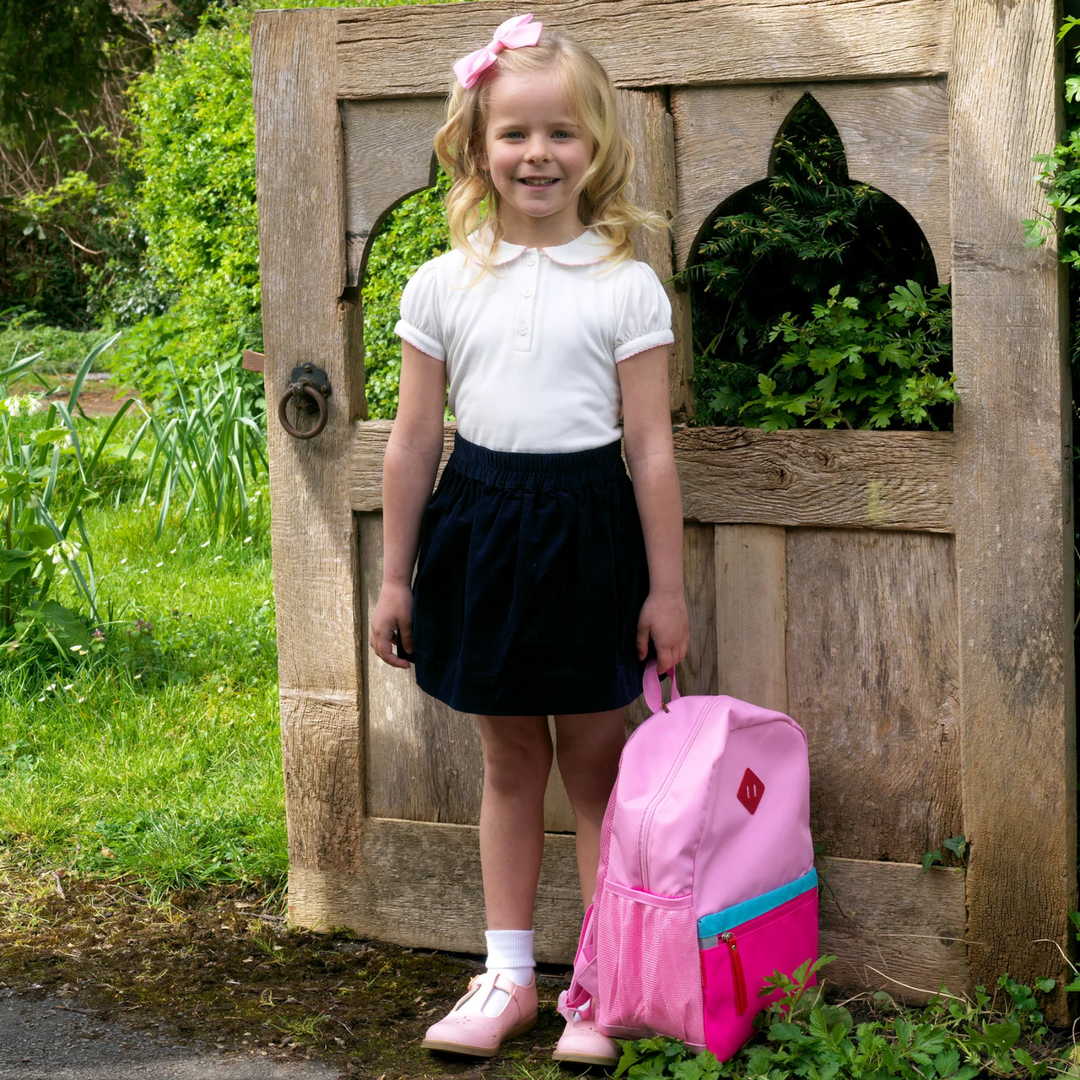 a little girl wearing Picot Trim Polo in Pink