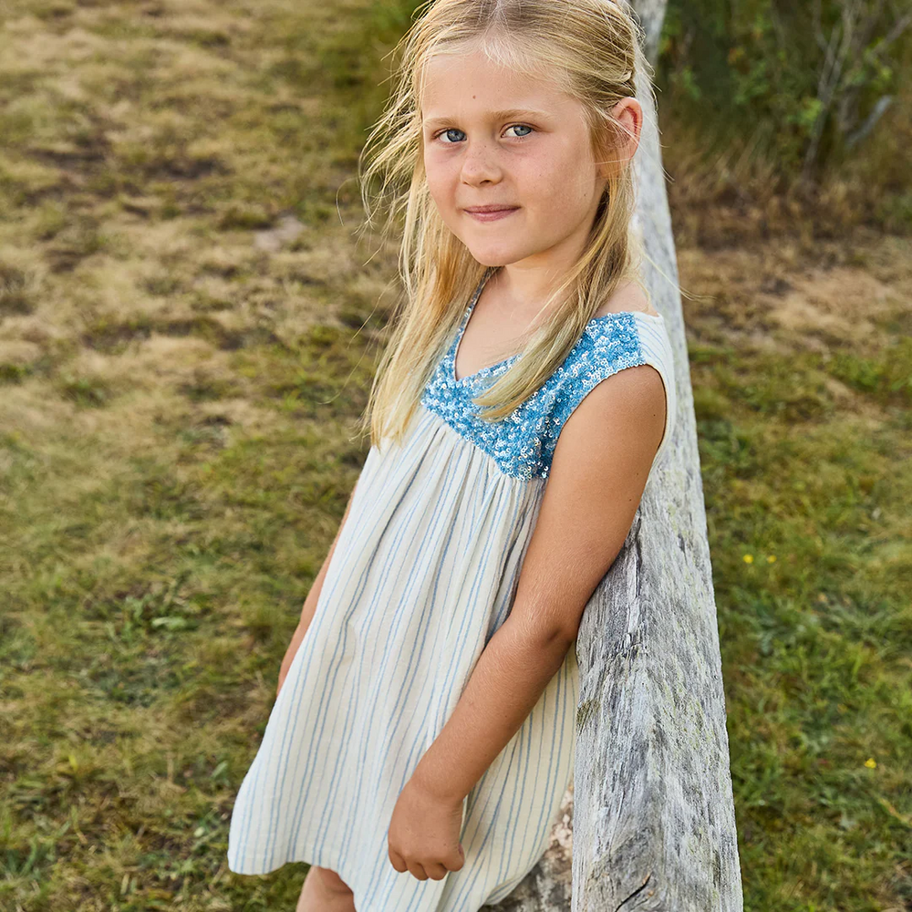 a little girl wearing Courtney Dress - Riviera Stripe