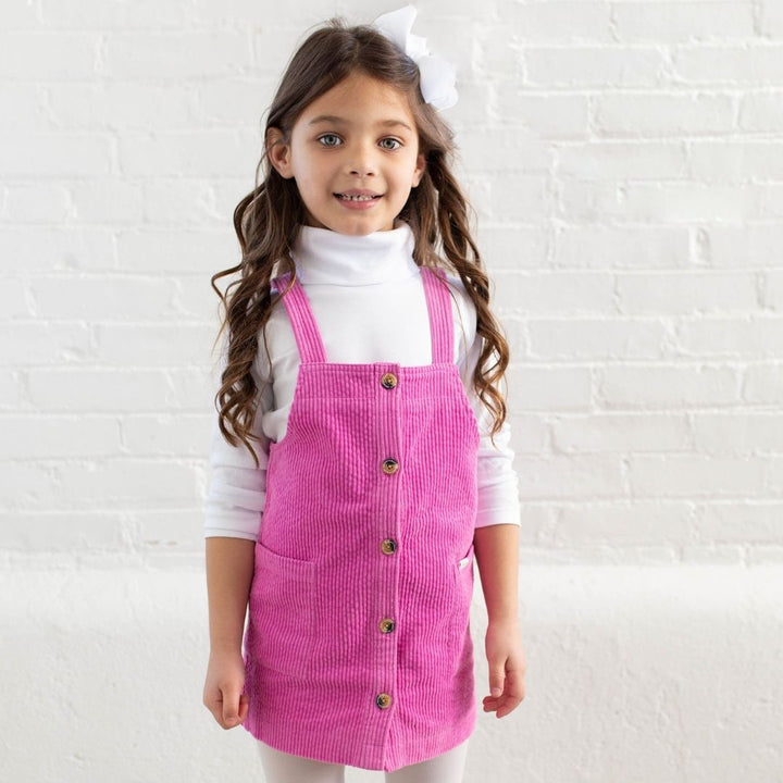 girl wearing pink cord jumper