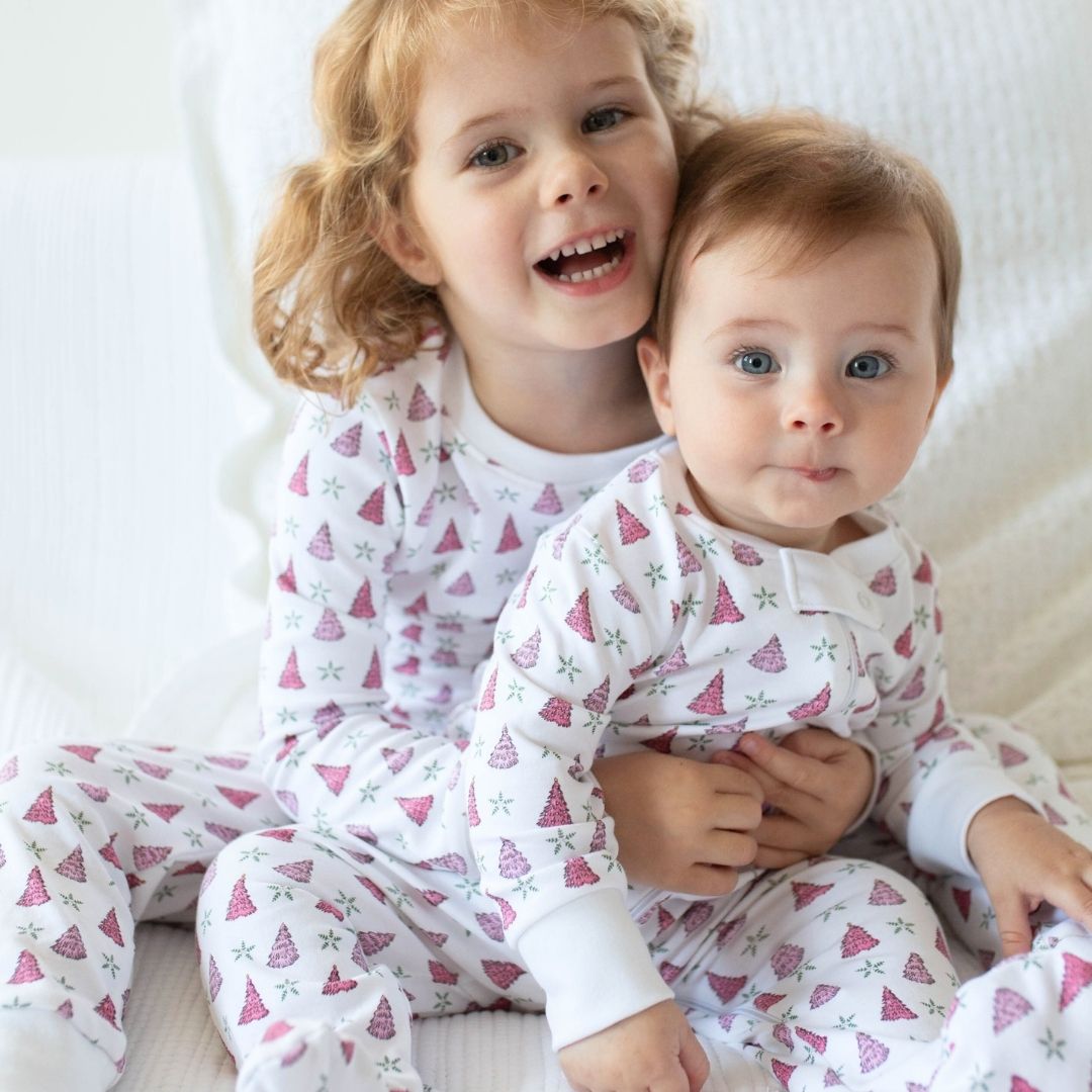 a kids wearing Holiday Tree Zipper Romper in Pink Frost