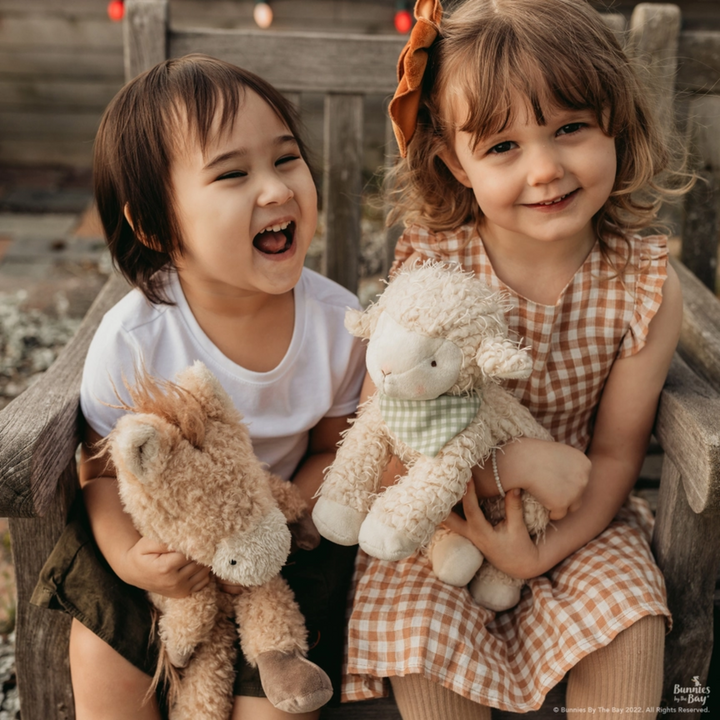 2 little girls sitting on a chair holding Pony Boy Horse