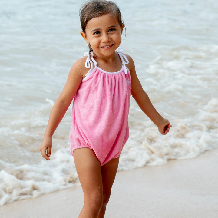 a girl wearing Poolside Terry Romper in Pink Carnation