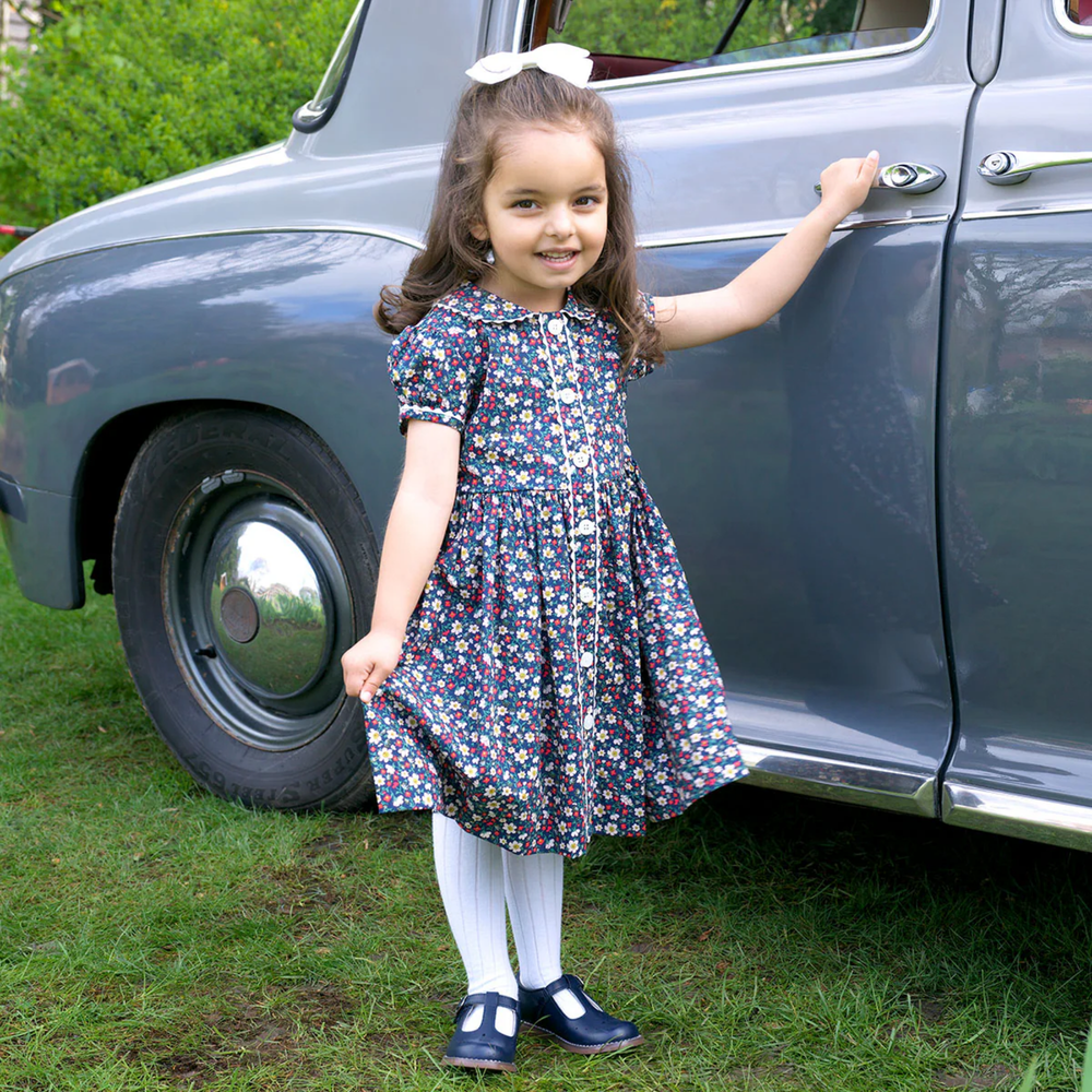 a little girl wearing Poppy Button-Front Dress in Navy