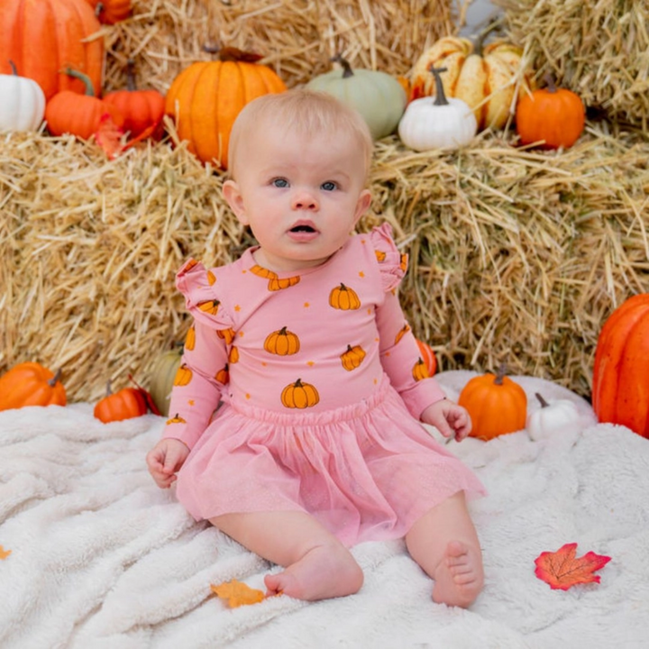 a baby girl wearing Pumpkin Blush Long Sleeve Tutu Bodysuit