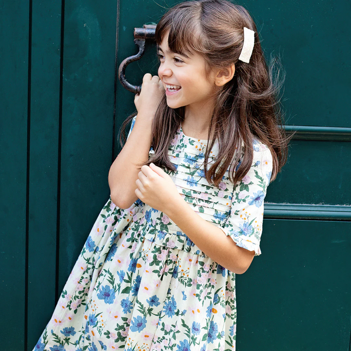 a girl wearing Raquel Dress - Melon Daisy Floral