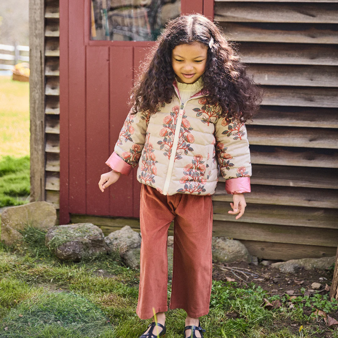 a girl wearing Reversible Riley Jacket - Cloud Bouquet Floral