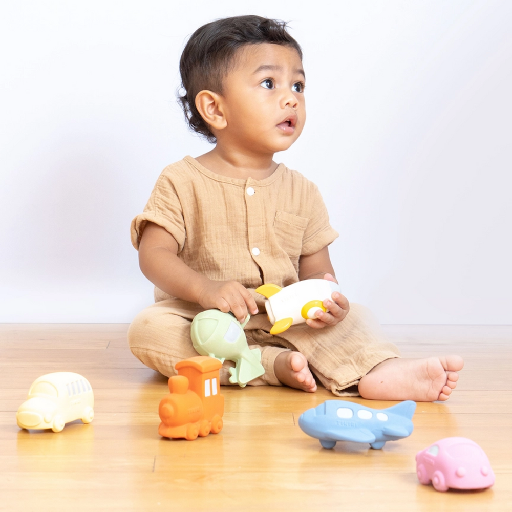 a baby boy playing Rocket Teether, Rattle & Bath Toy