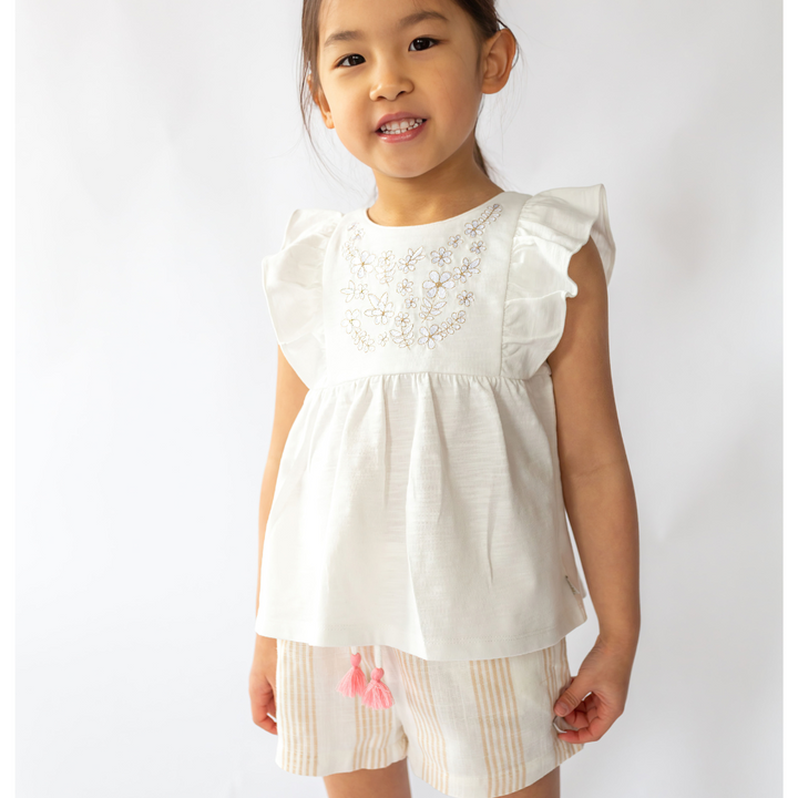 a little girl wearing Kelly Linen Short in Desert Mirage Stripe