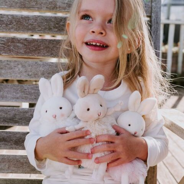 a girl holding the Rutabaga Roly Poly Bunny