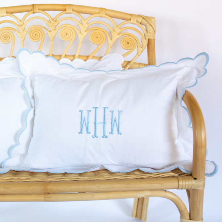 Classic Scalloped Baby Pillow in Blue in a chair