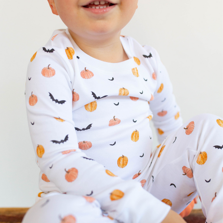 a kid wearing Scary Pumpkin Pajama Set