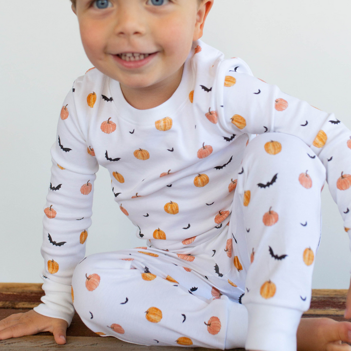 a boy wearing Scary Pumpkin Pajama Set