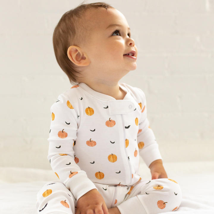 a baby wearing Scary Pumpkin Zipper Romper