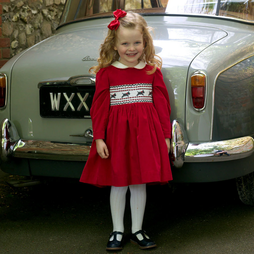 a girl wearing Scottie Dog Smocked Dress in Red