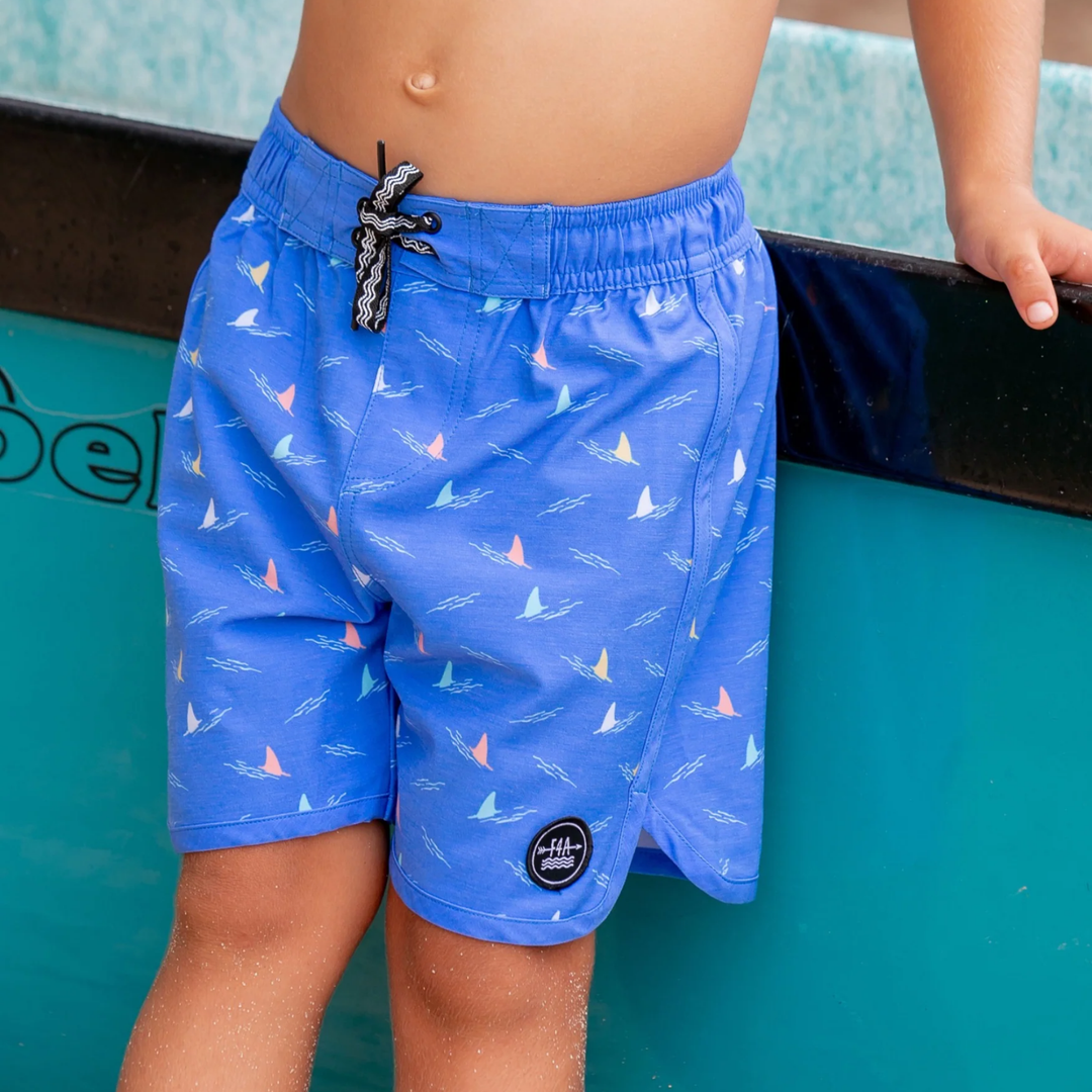 a baby wearing Shark Fin Baby Boardshort in Marina Blue