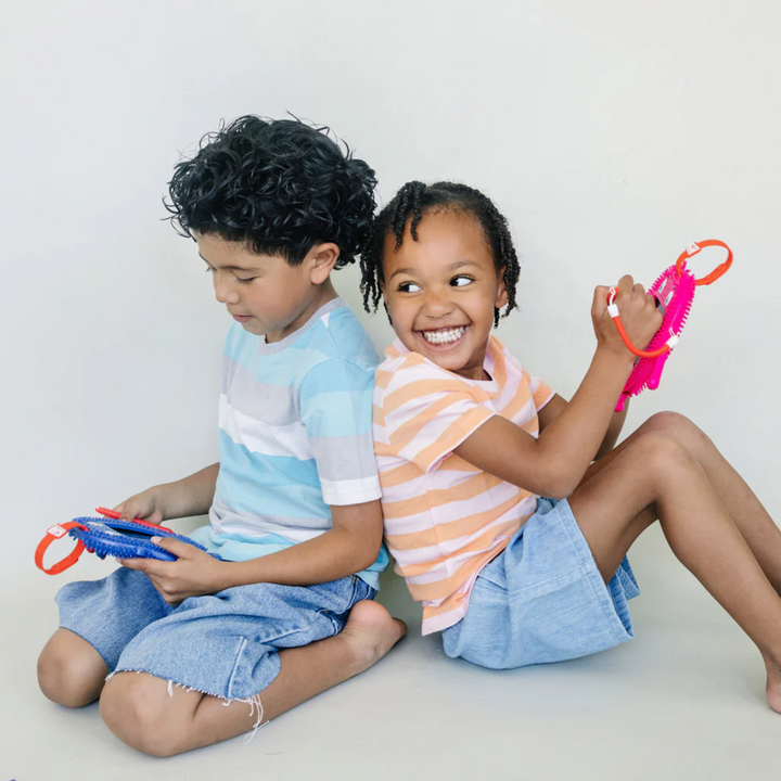 a kids playing Sketch Pals Doodle Board: Pink Fidgety Friends