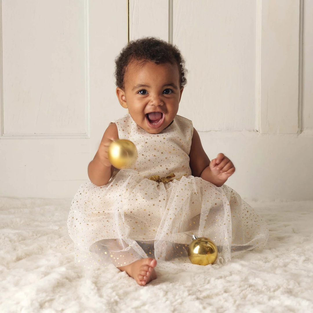 a baby girl wearing Sparkle Star Tulle Dress in Ivory