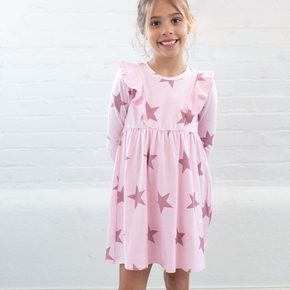 girl wearing pink star dress