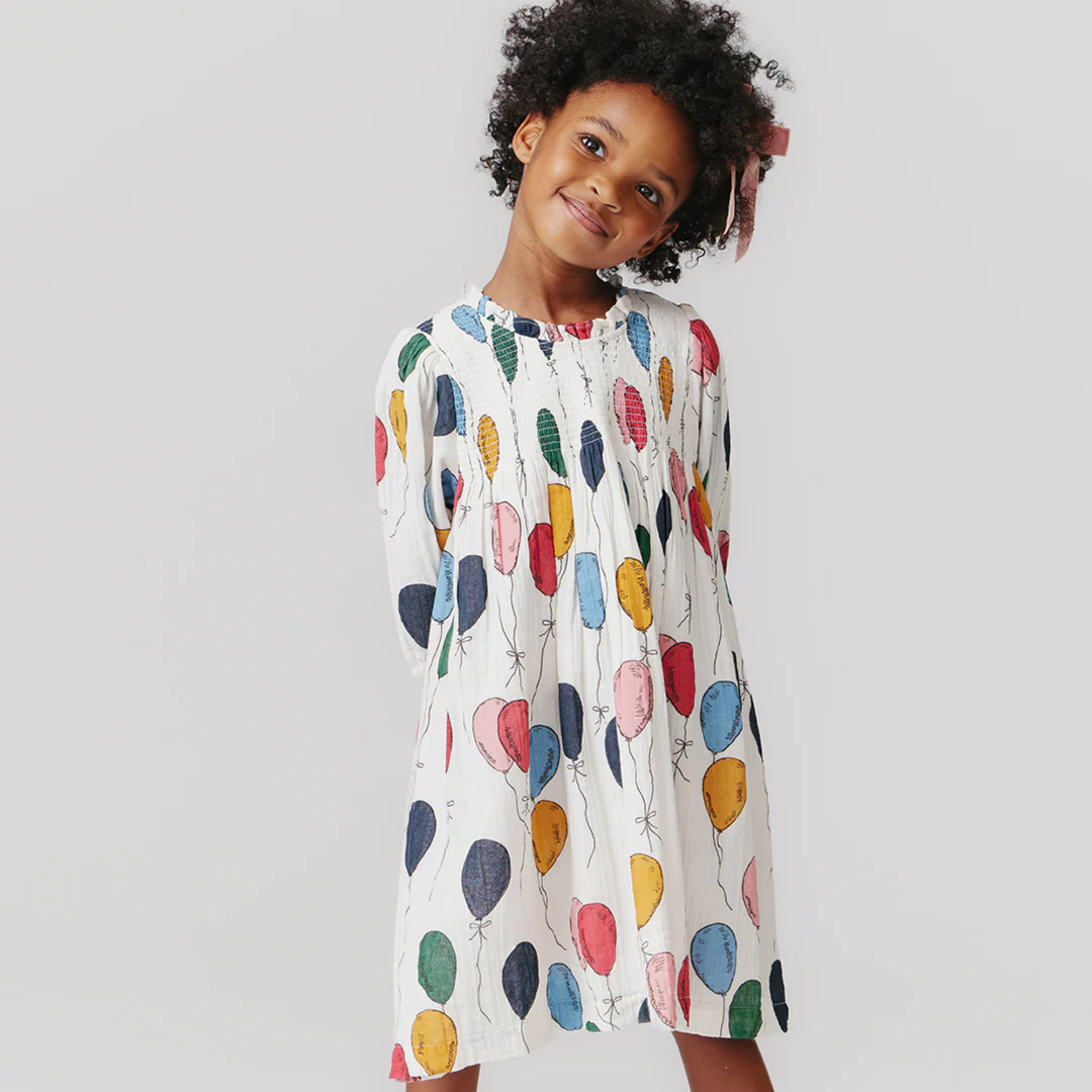 a girl wearing Stevie Puff Sleeve Dress - Balloon Bunches