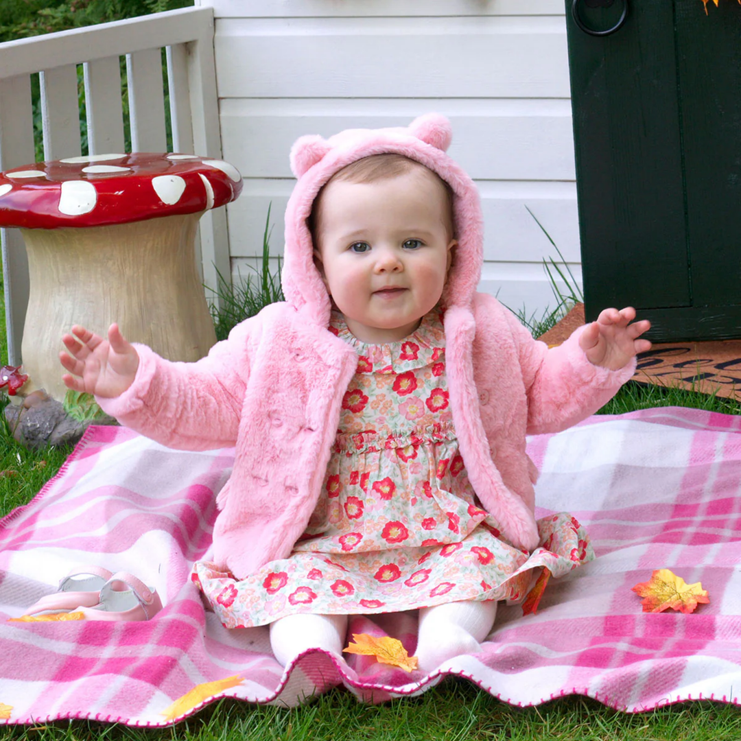 a baby wearing Teddy Coat in Pink