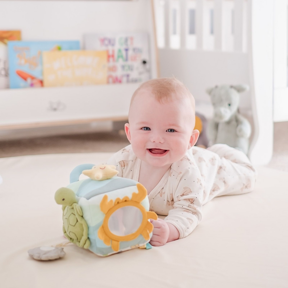 Ocean Activity Cube Developmental Toy with a baby