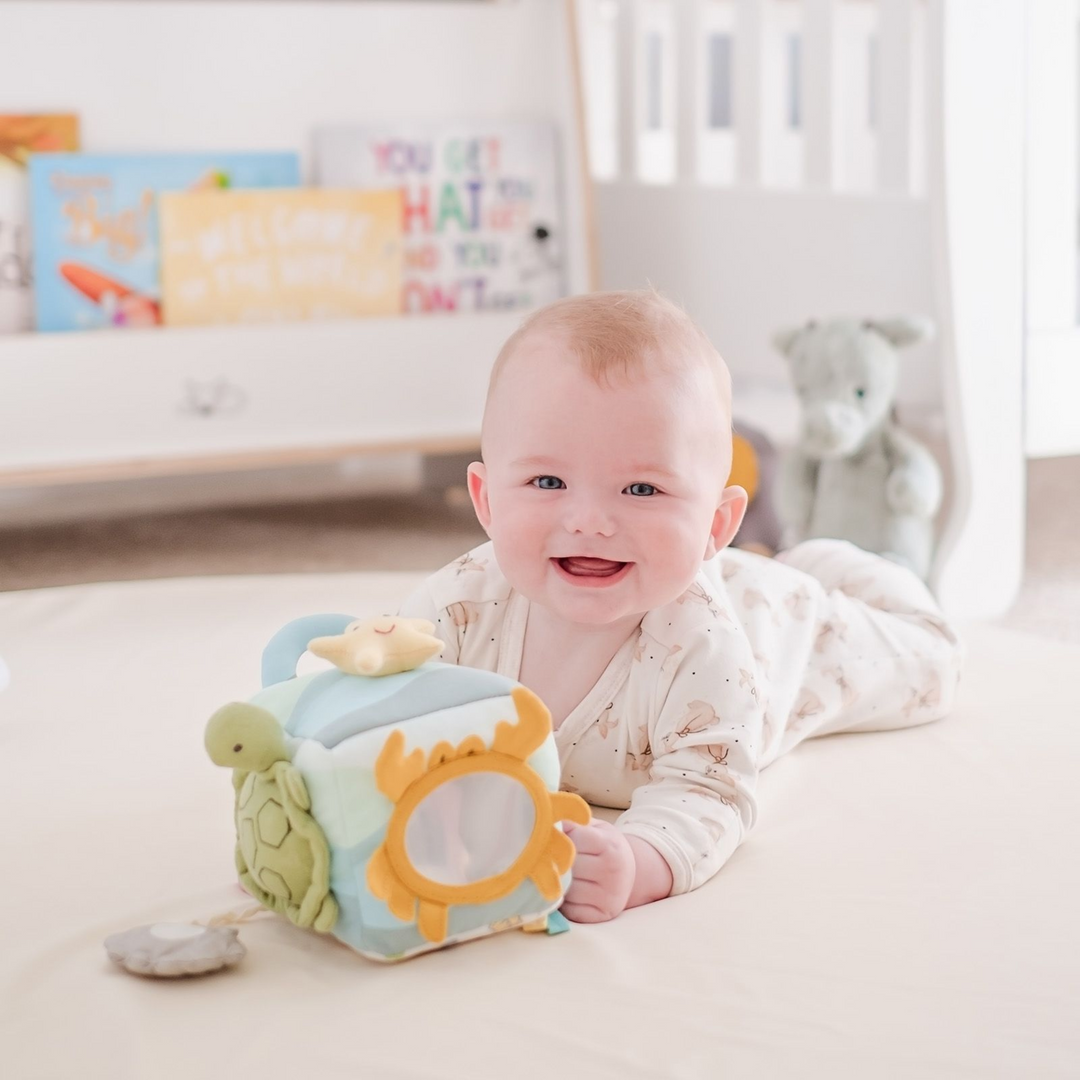 Ocean Activity Cube Developmental Toy with a baby