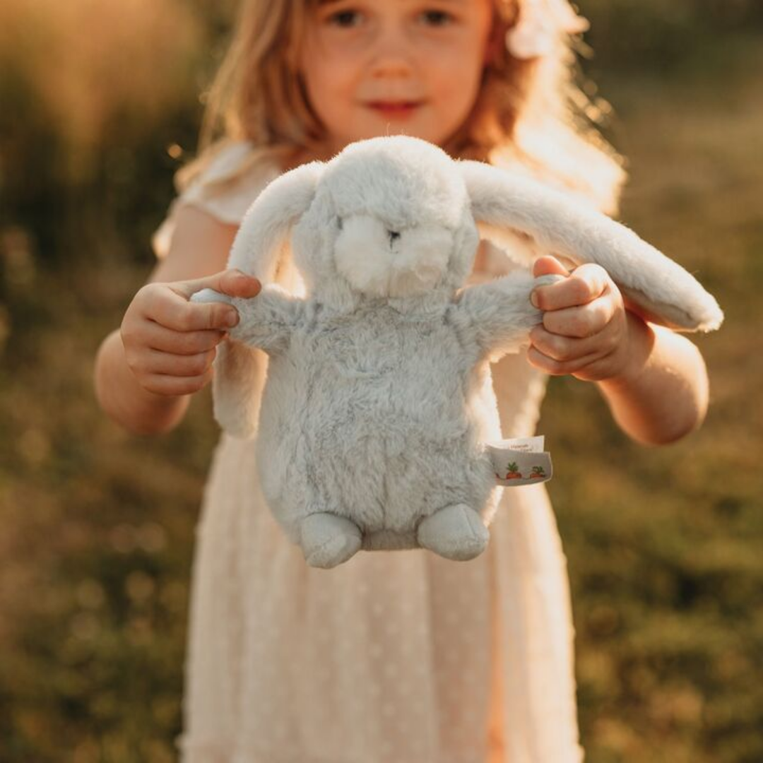 a girl holding the Tiny Nibble Gray Bunny