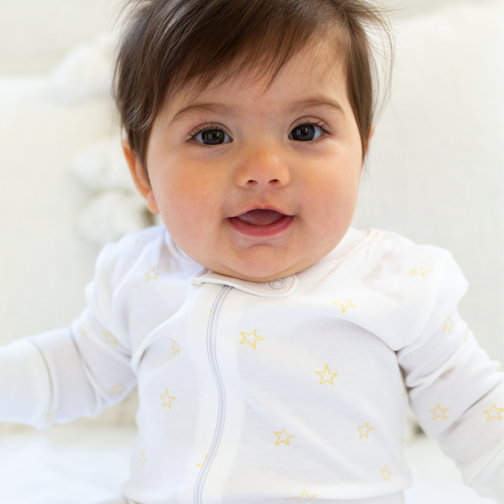 a baby wearing Tiny Stars Zipper Romper in Yellow
