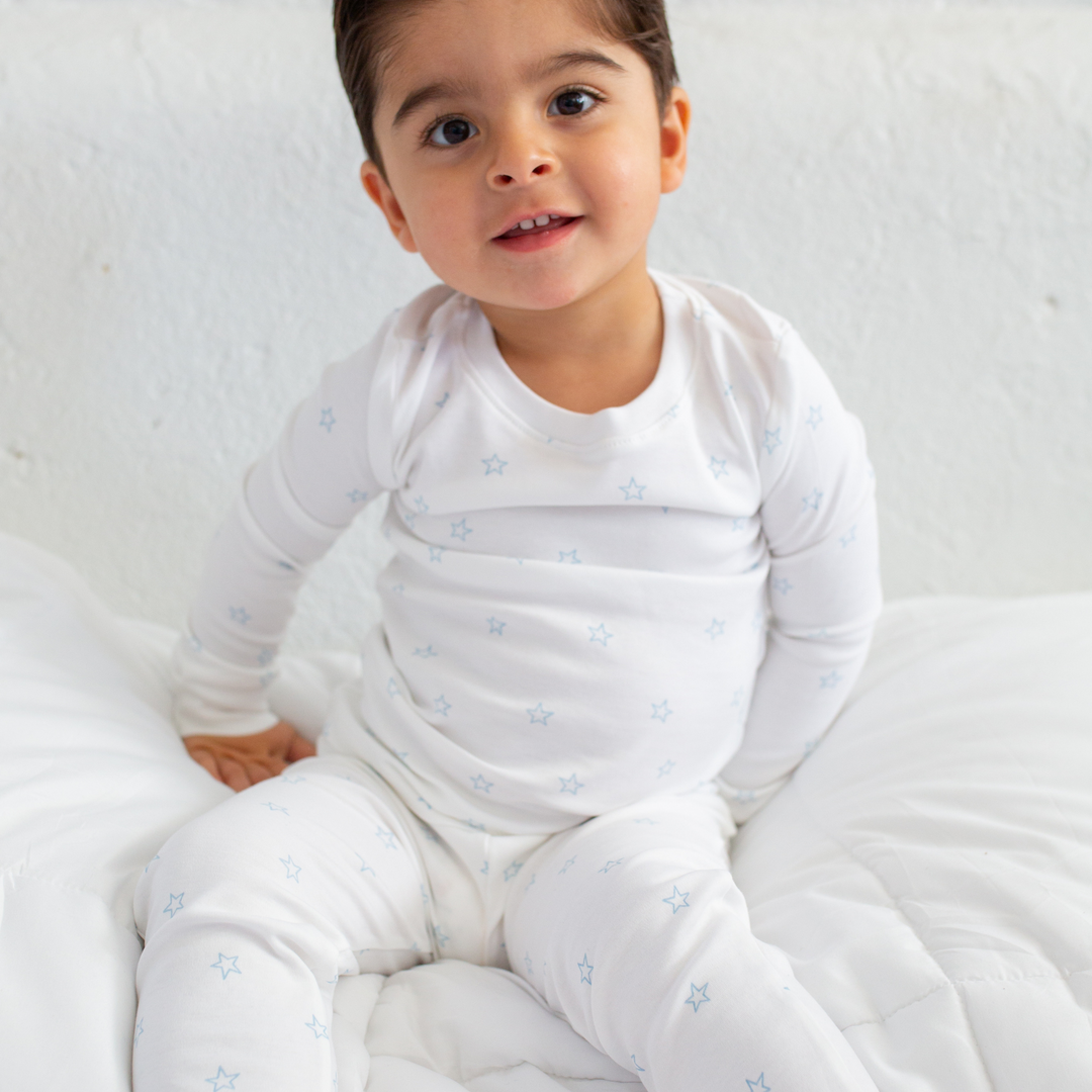 a little boy wearing Tiny Stars Pajama Set in Light Blue