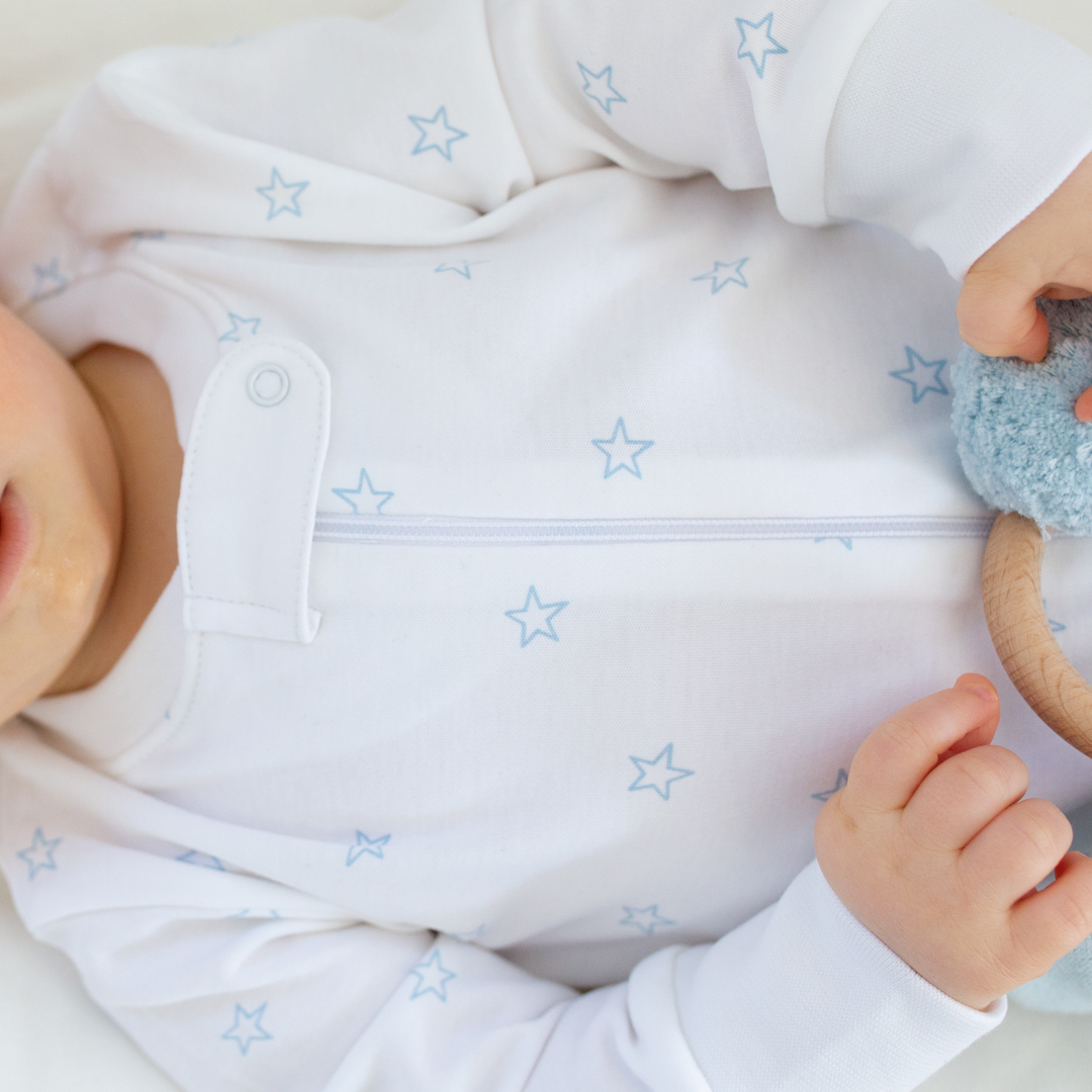 a baby wearing Tiny Stars Zipper Romper in Light Blue