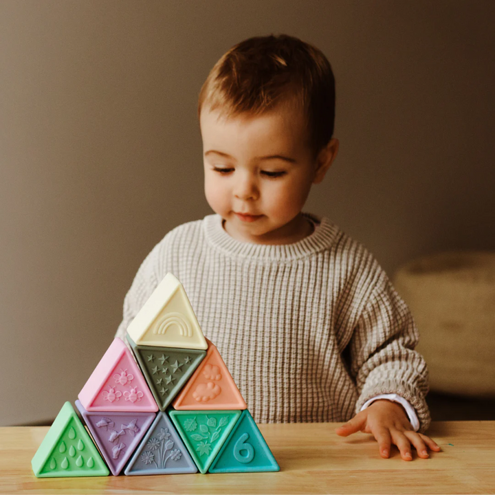 a baby playing Triblox - Pastel