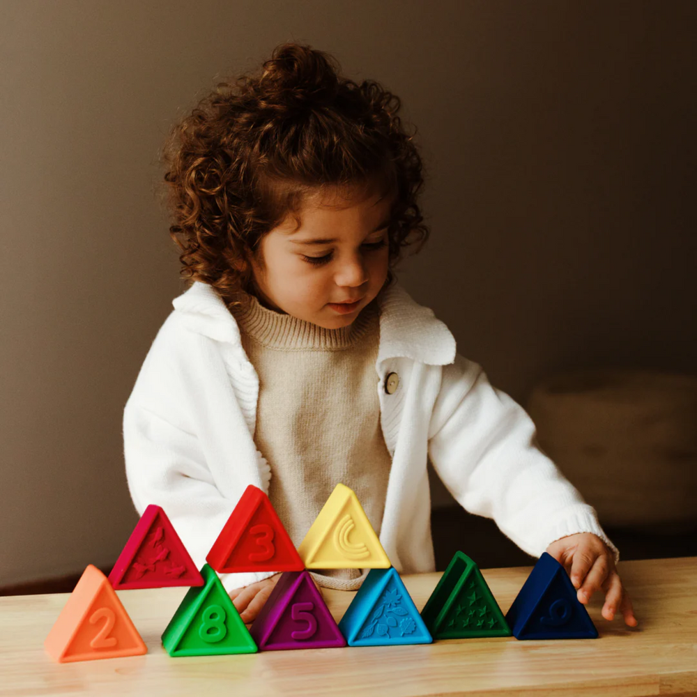 a baby playing Triblox - Rainbow