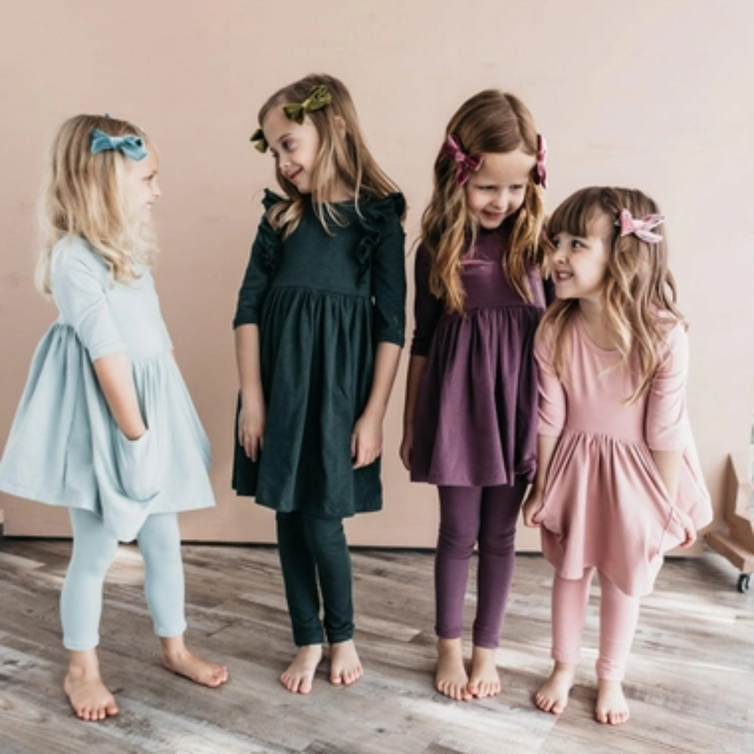 a little girl wearing Vintage Pink Pocket Twirl Dress