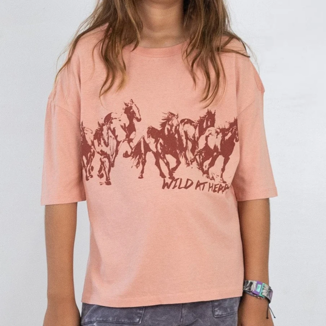 a little girl wearing Wild At Heart Super Tee in Blush