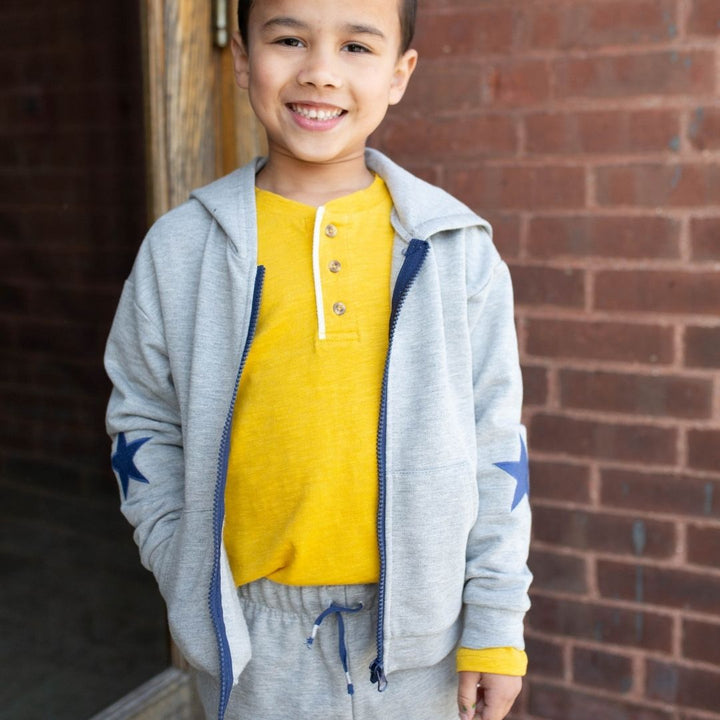 boy wearing yellow henley