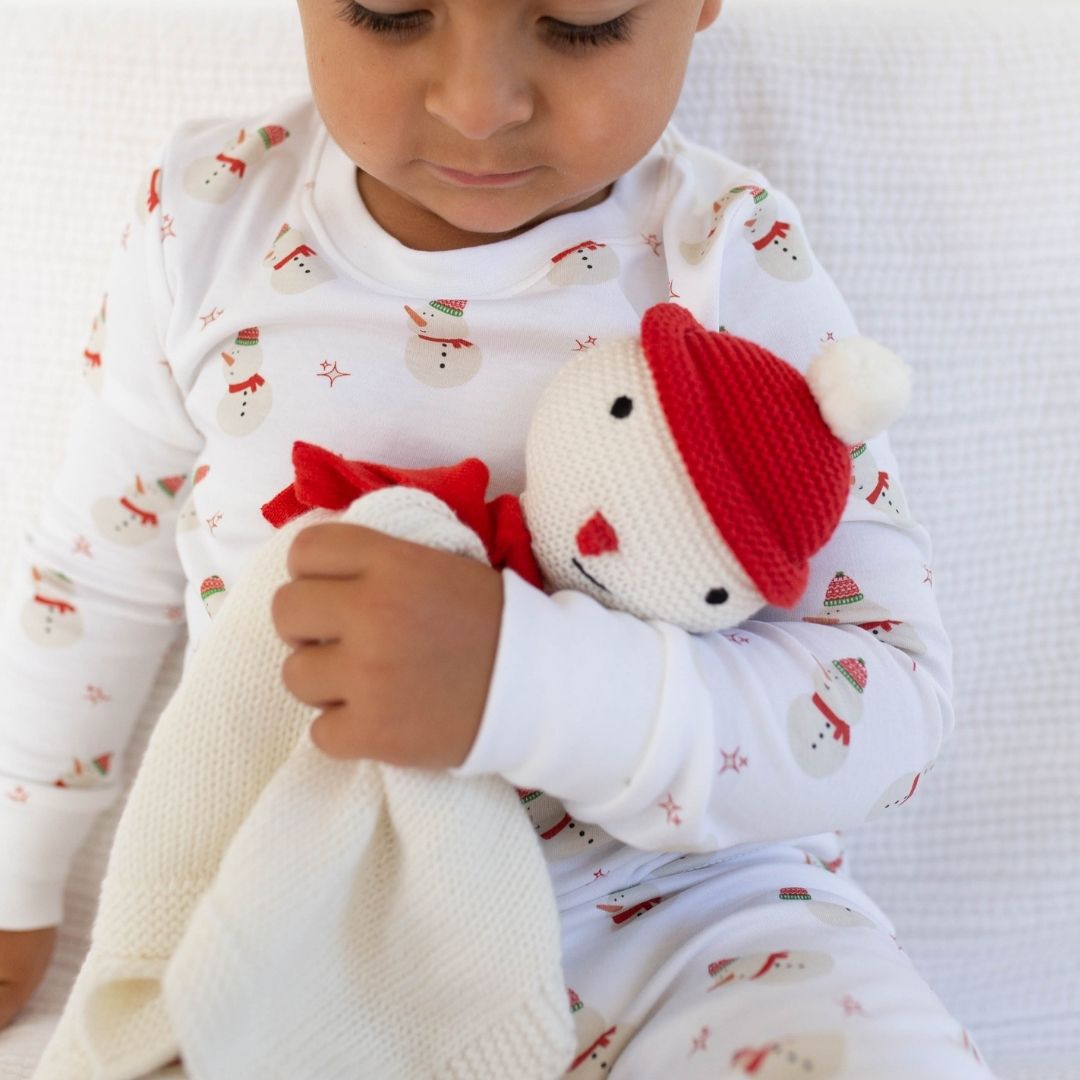 Child holding snowman