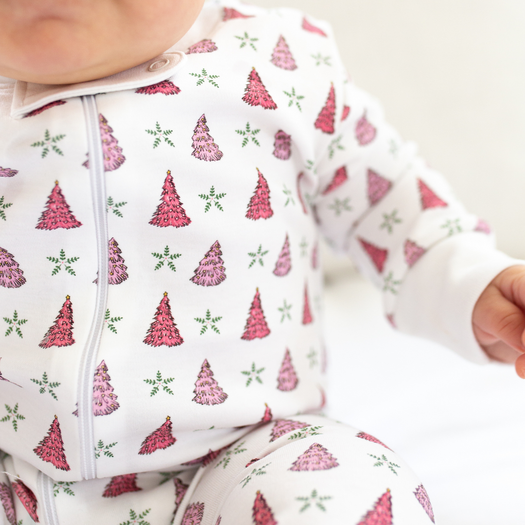 a baby wearing Holiday Tree Zipper Romper in Pink Frost