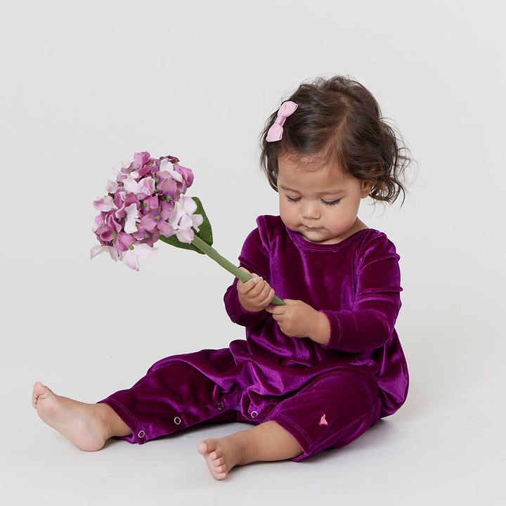 baby girl with pink velour jumper