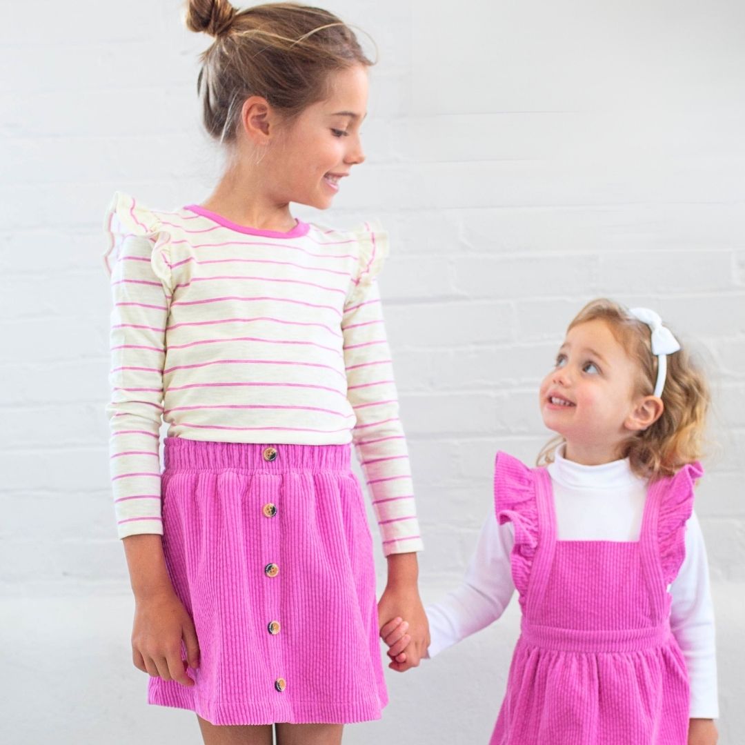 girl wearing kara top pink stripe