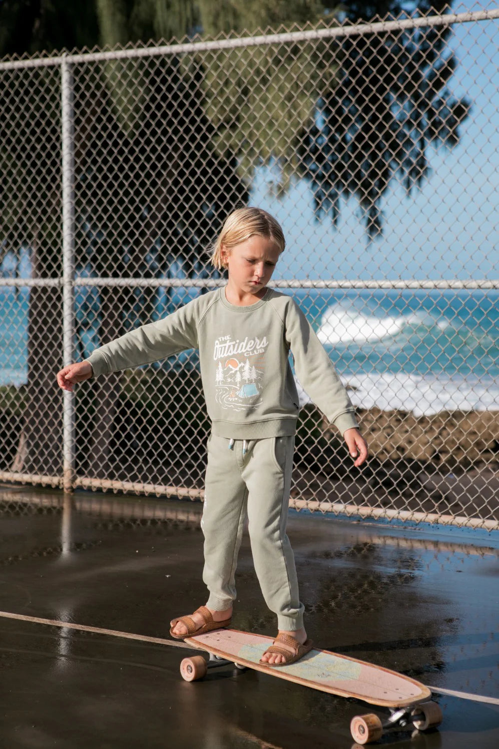 boy skateboarding in green sweatpants