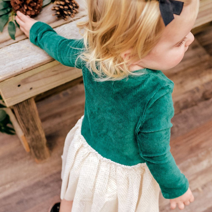 little girl wearing green dress