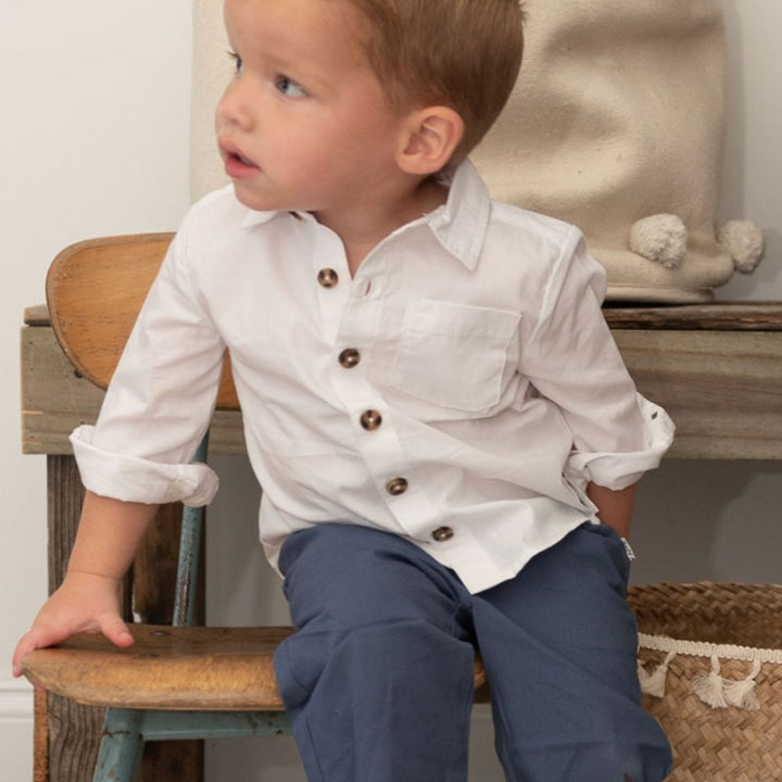 boy wearing blue pants white buttondown