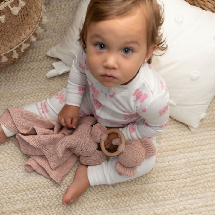 little girl holding elephant lovey