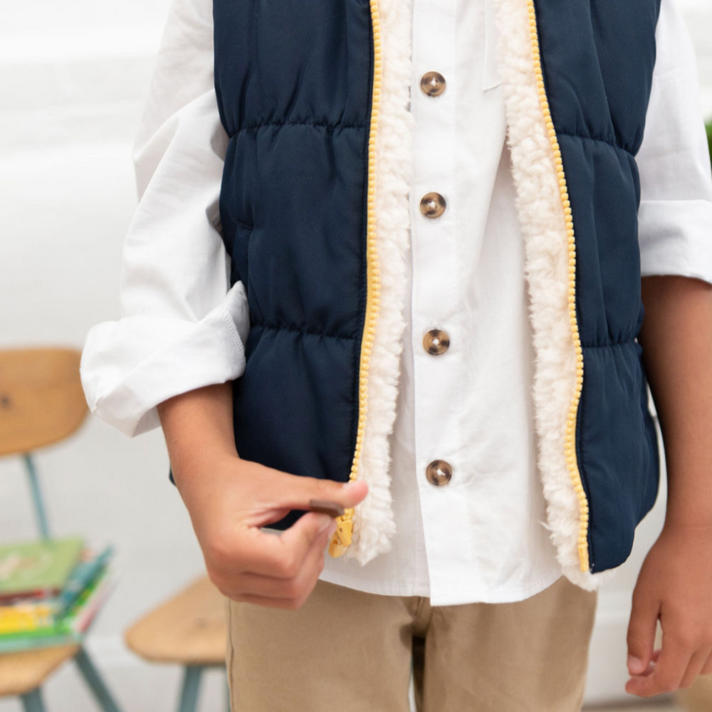 boy wearing white buttondown with sherpa vest